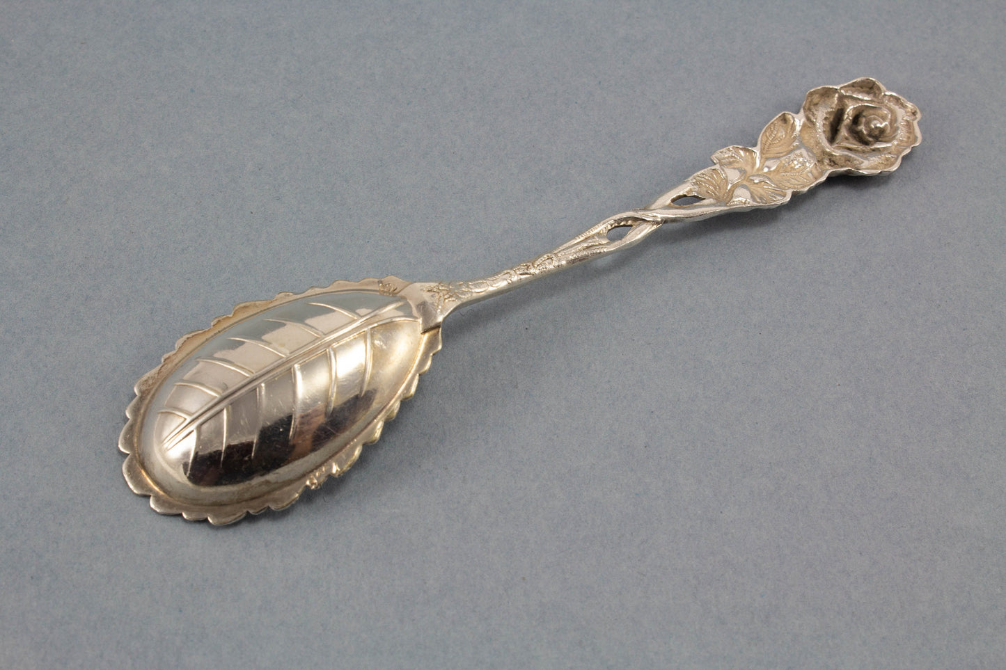 Small sugar spoon with roses, silver plated