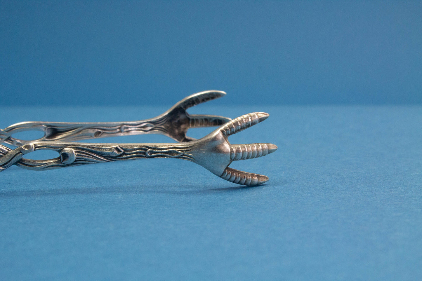 Silver plated sugar tongs with roses
