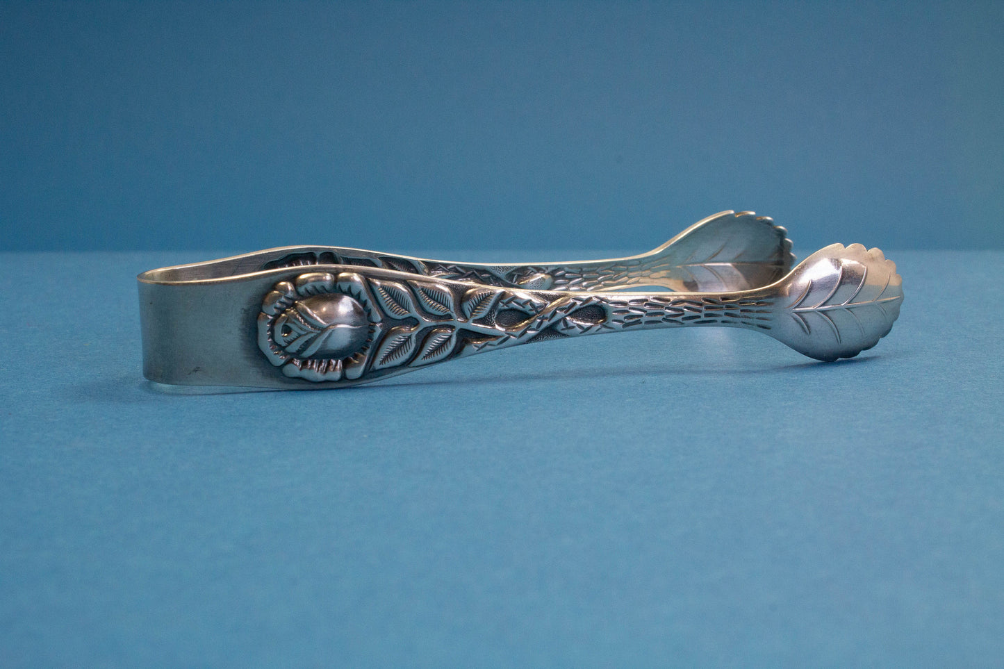 Silver plated sugar tongs with roses
