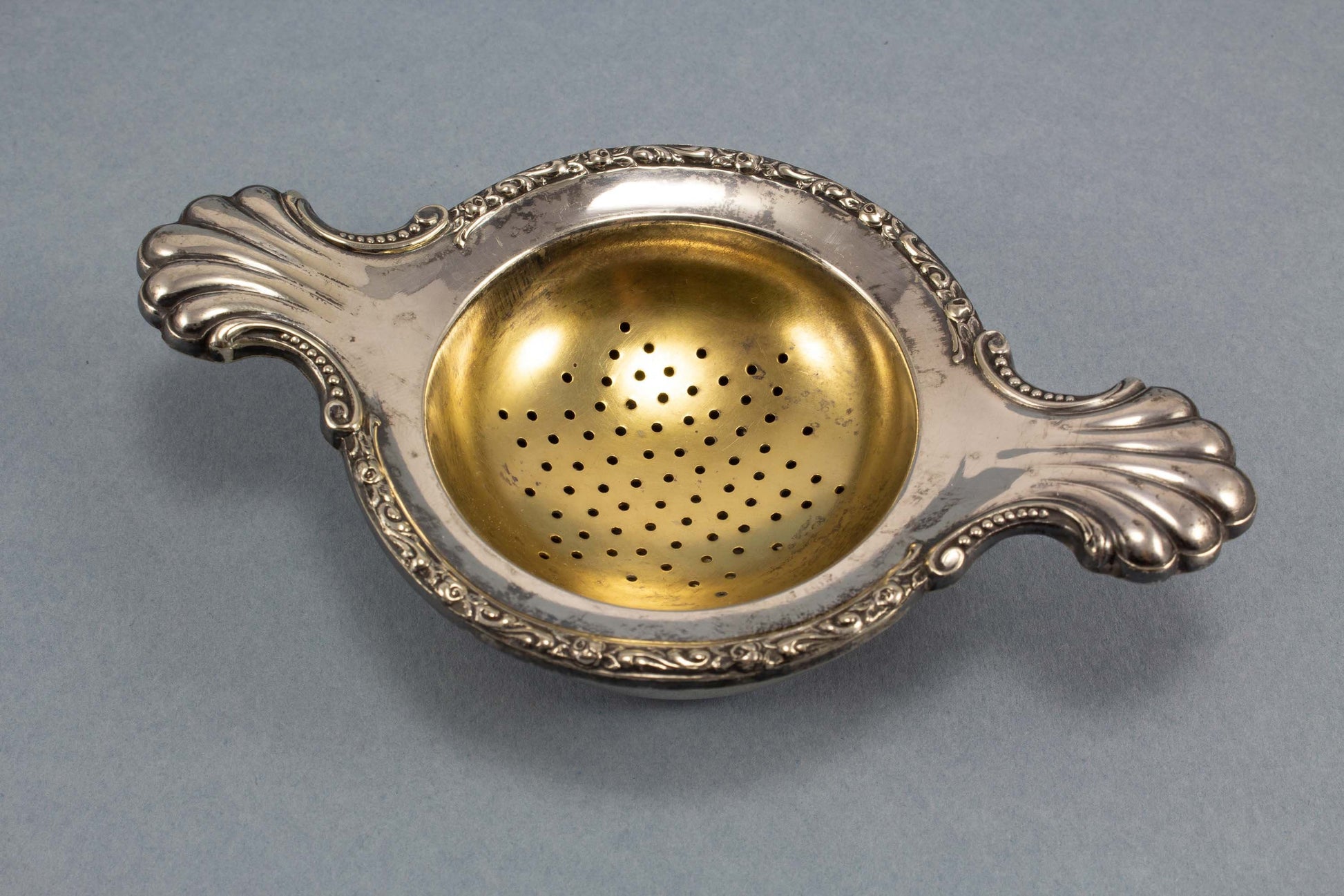 Silver-plated tea strainer with Art Nouveau decorations