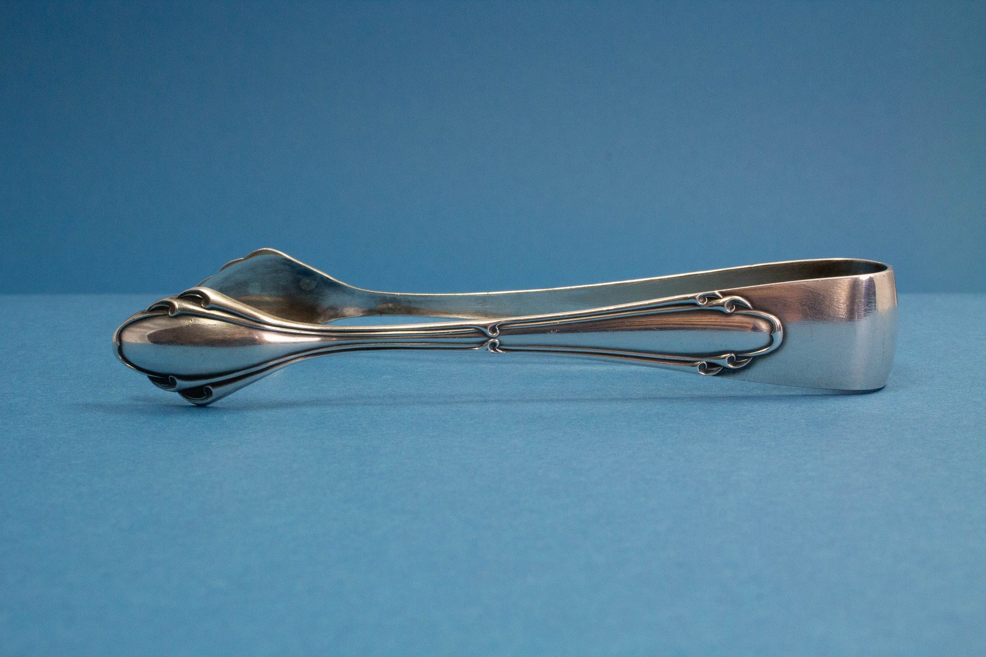 Silver plated sugar tongs with art nouveau pattern