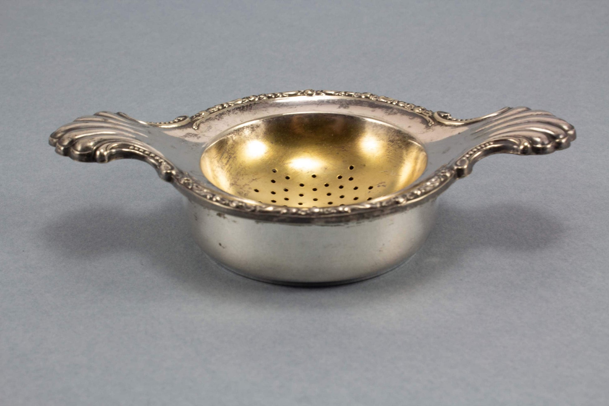 Silver-plated tea strainer with Art Nouveau decorations