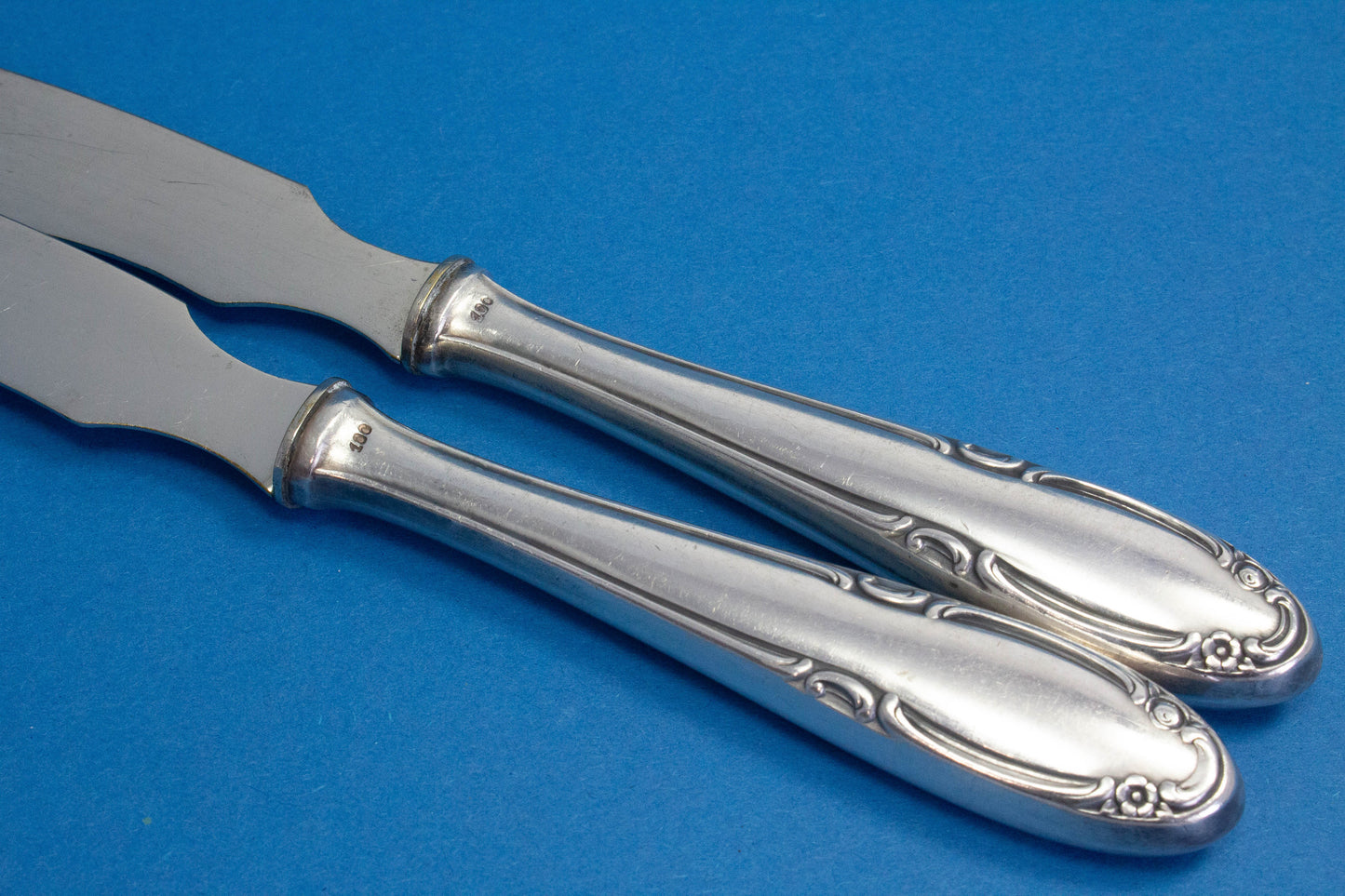 Silver-plated cheese knives and butter knives with small flowers